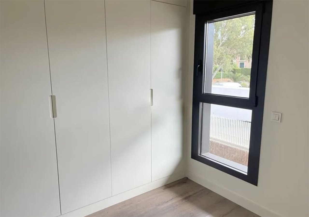 Modernes Schlafzimmer mit bodentiefen Fenstern und praktischen Einbauschränken Modernes Schlafzimmer mit bodentiefen Fenstern und praktischen Einbauschränken