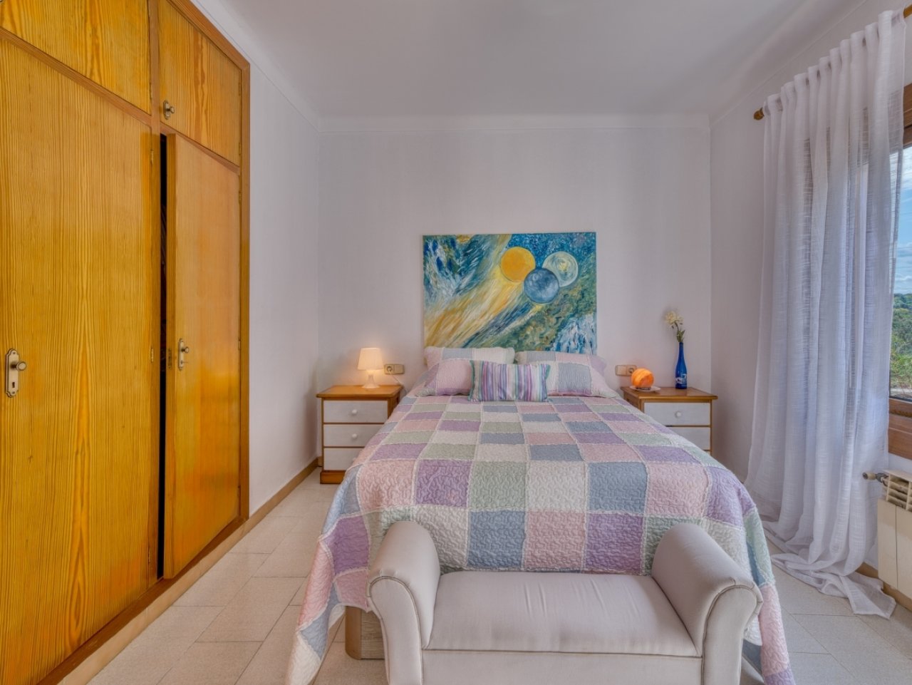 Helles Schlafzimmer mit praktischer Schrankwand, Fensterfront und wohlproportioniertem Raumangebot