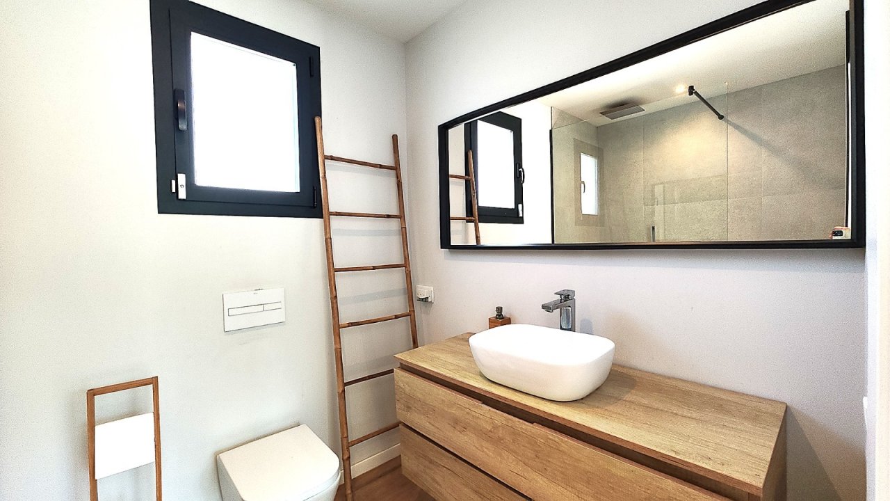 Modernes Badezimmer mit großformatigem Spiegel und bodenebener Dusche Modernes Badezimmer mit großformatigem Spiegel und bodenebener Dusche