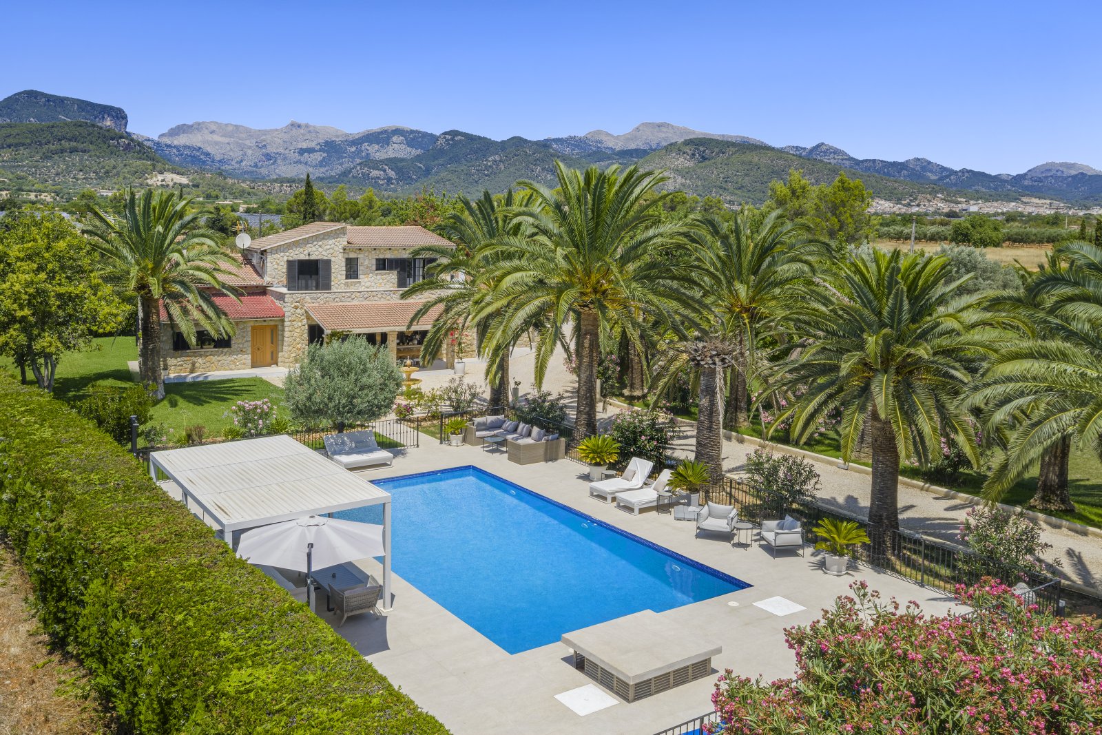 Panoramablick auf die Berglandschaft – Poolanlage mit weitläufigem Außenbereich und integriertem Sonnenschutzsystem Panoramablick auf die Berglandschaft – Poolanlage mit weitläufigem Außenbereich und integriertem Sonnenschutzsystem