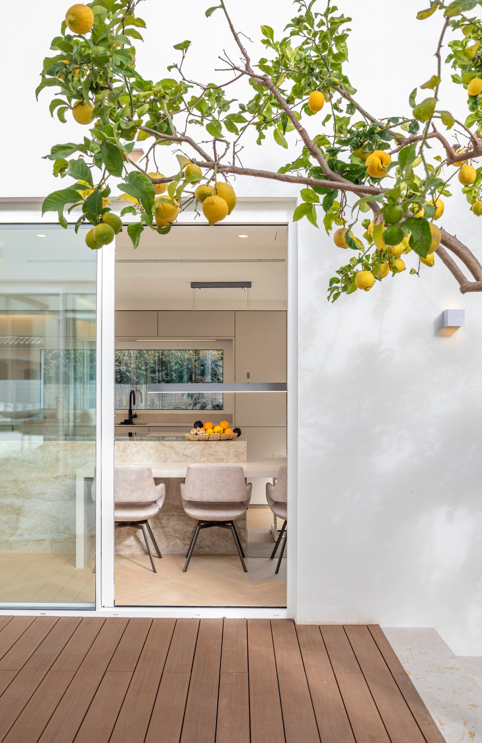 Terrasse mit direktem Blick in die moderne Wohnküche – fließender Übergang zwischen Innen und Außen