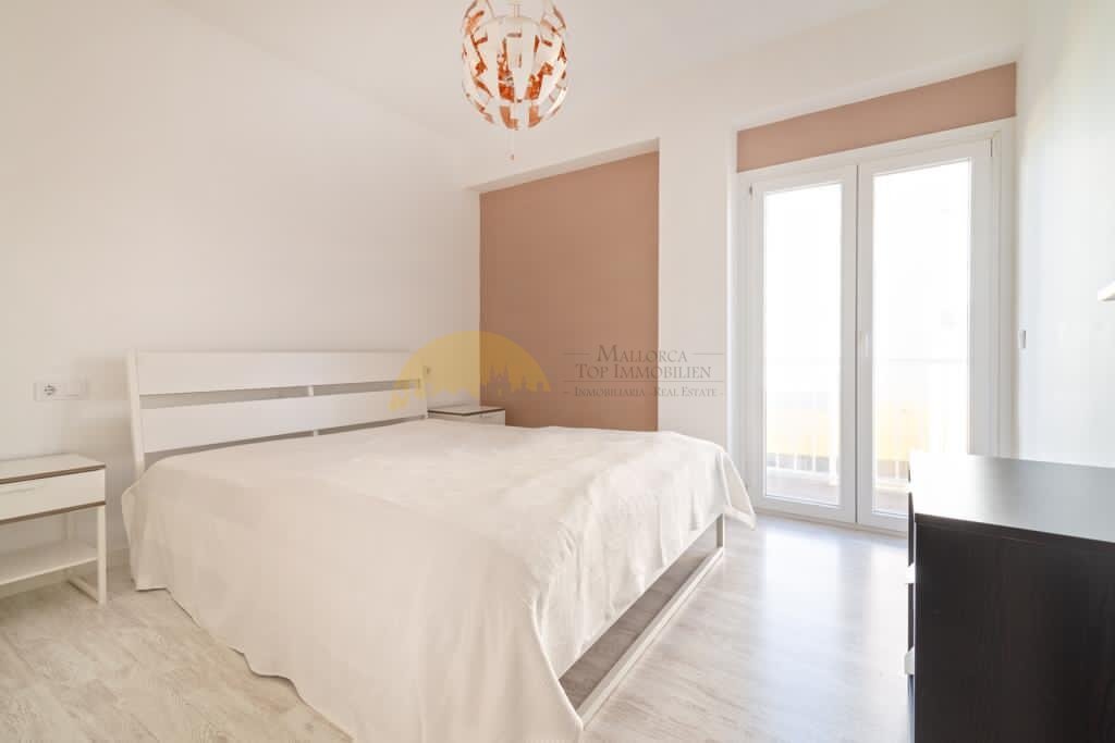 Helles Schlafzimmer mit französischen Glastüren und Terrassenzugang