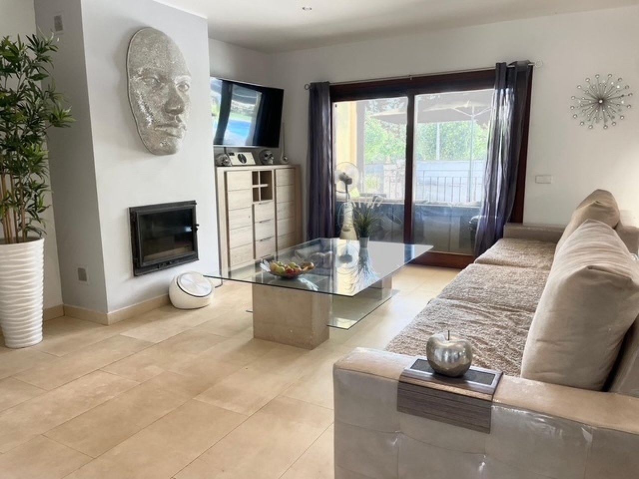 Wohnzimmer mit Kaminanlage und direktem Zugang zur Terrasse