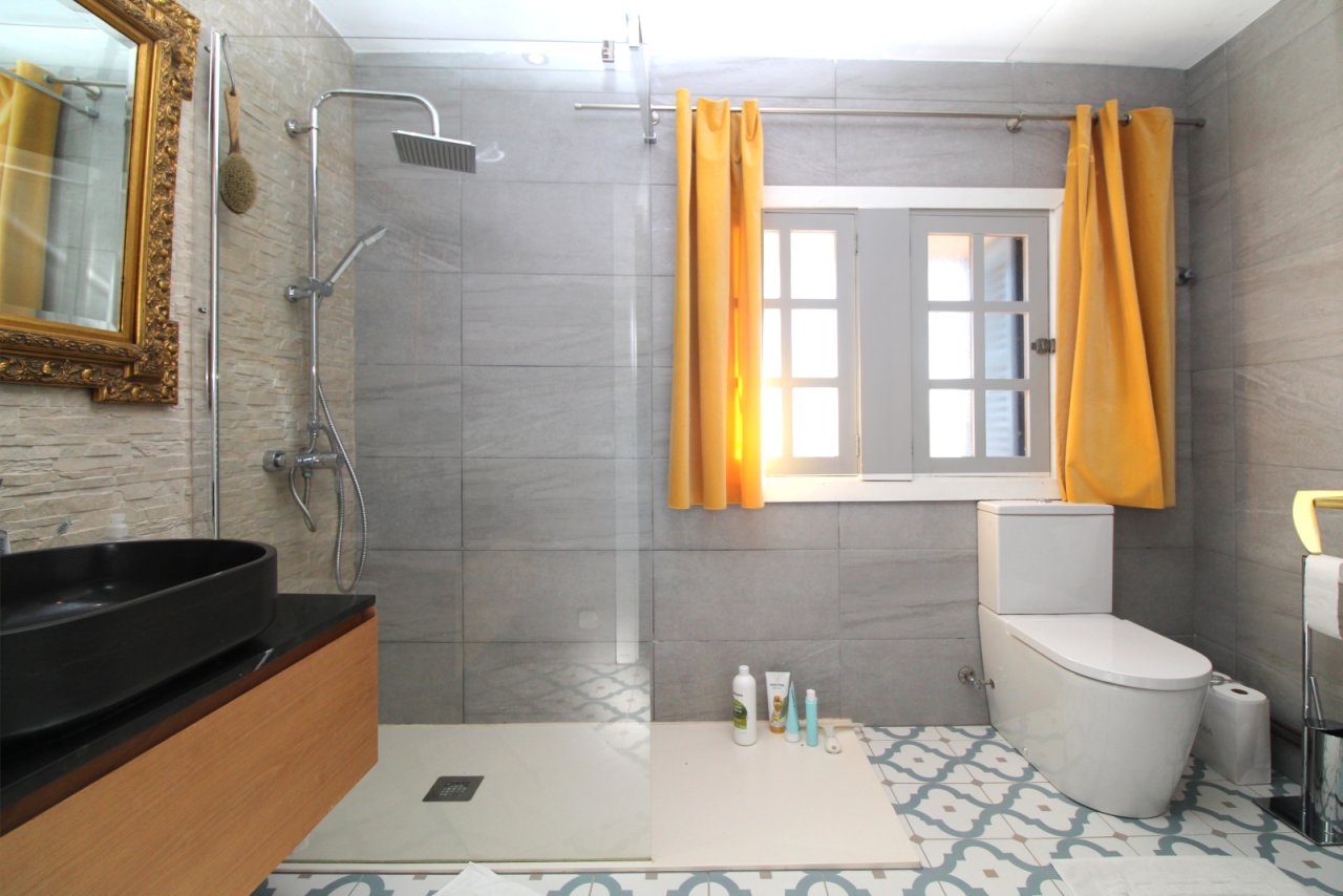 Modernes Badezimmer mit bodengleicher Dusche, Doppelwaschtisch und großflächiger Fensterfront