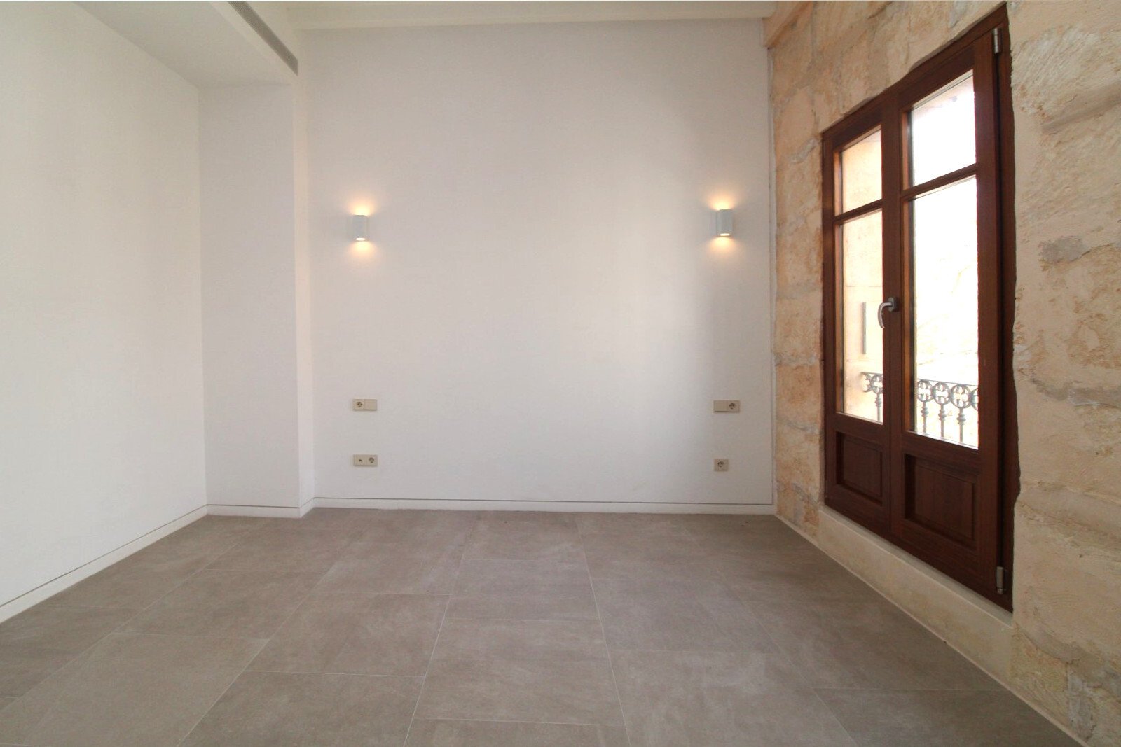 Helles Zimmer mit eleganten Glastüren und durchdachter Beleuchtung Helles Zimmer mit eleganten Glastüren und durchdachter Beleuchtung