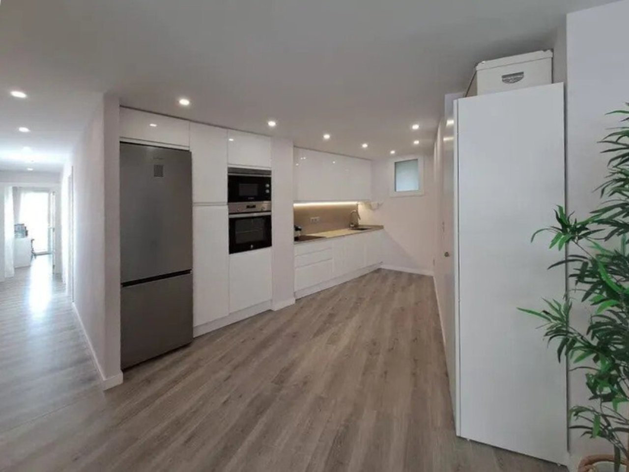 Modern kitchen with integrated dining area and smart space utilization