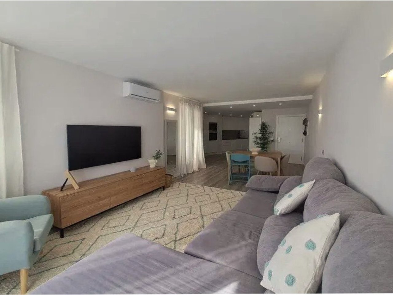 Open living and dining area with smart layout and air conditioning
