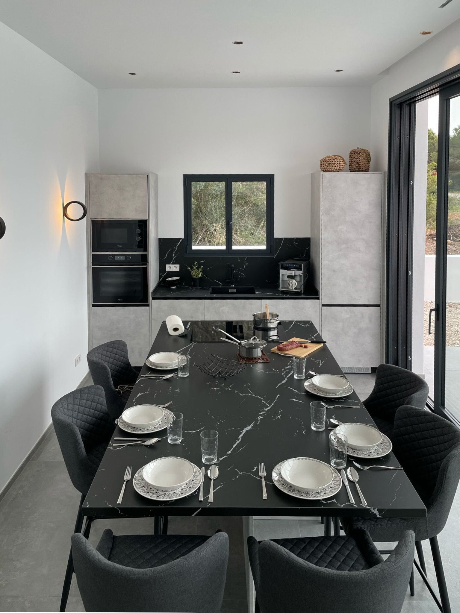 Modern open-plan kitchen with smart layout and direct terrace access Modern open-plan kitchen with smart layout and direct terrace access