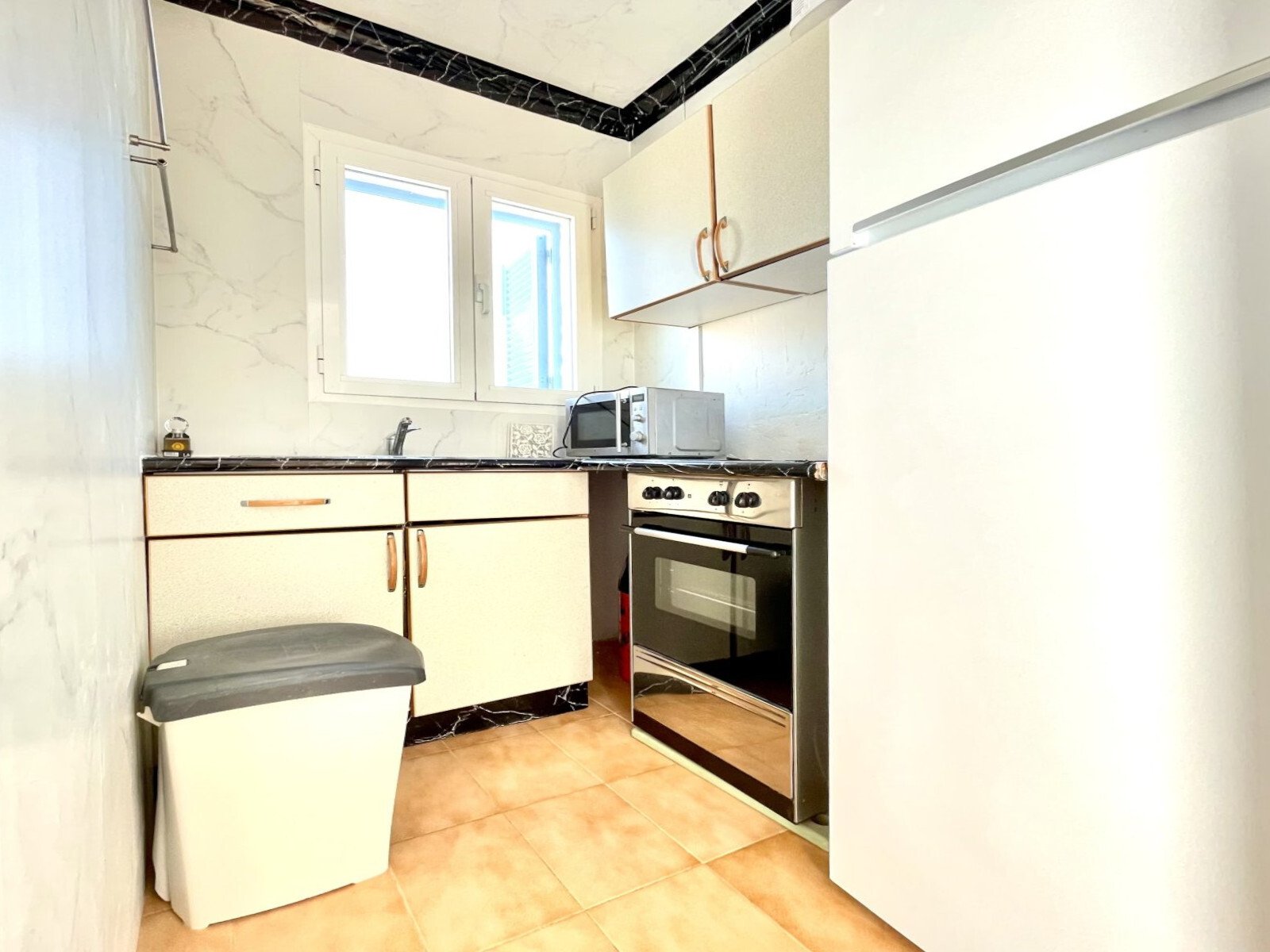 Functional kitchen with practical workspace layout and complete appliance equipment Functional kitchen with practical workspace layout and complete appliance equipment