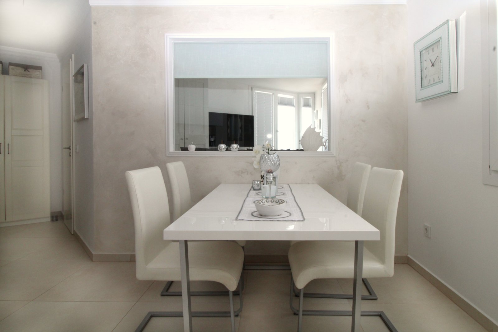 Elegant dining room with full-height mirror and open sightline to the living area Elegant dining room with full-height mirror and open sightline to the living area