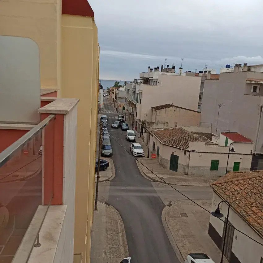 Balcony with a view of the busy street and neighboring buildings