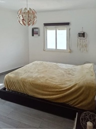 Bright bedroom with large window and optimal space utilization Bright bedroom with large window and optimal space utilization
