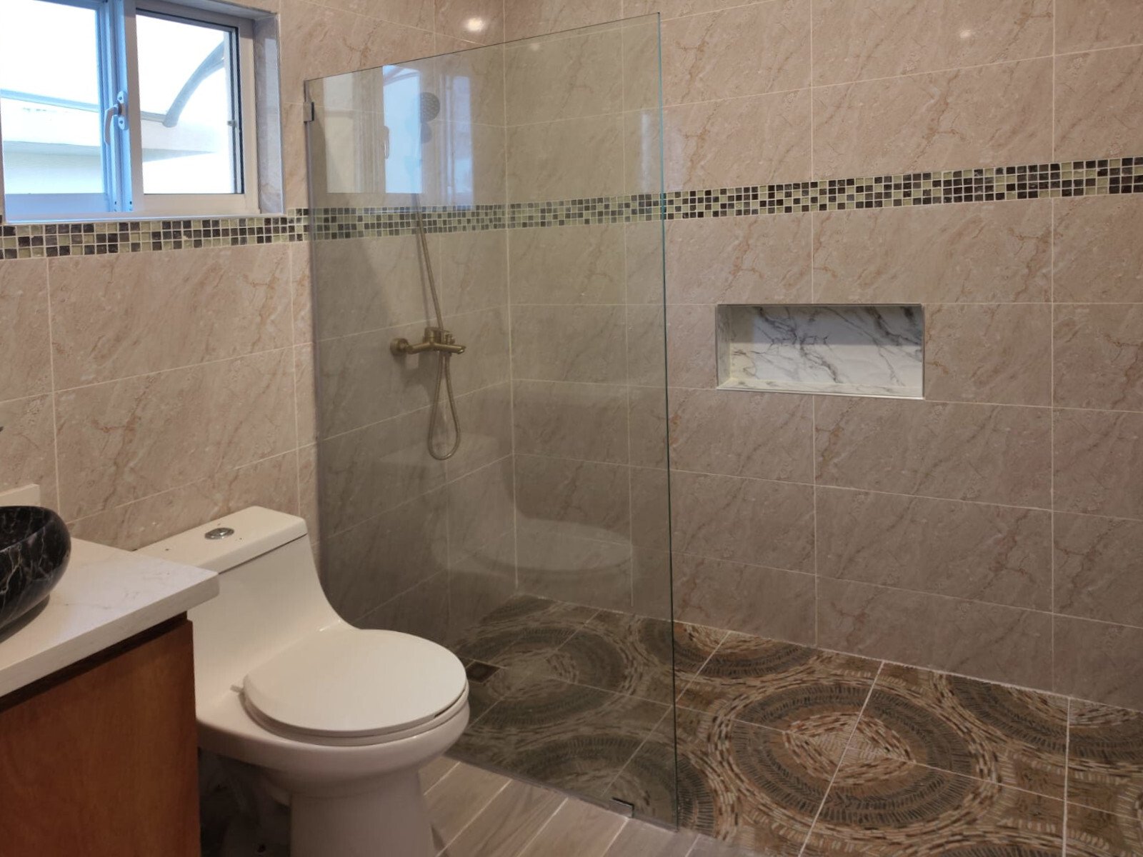 Modern bathroom with walk-in shower, niche solution, and window ventilation. Modern bathroom with walk-in shower, niche solution, and window ventilation.