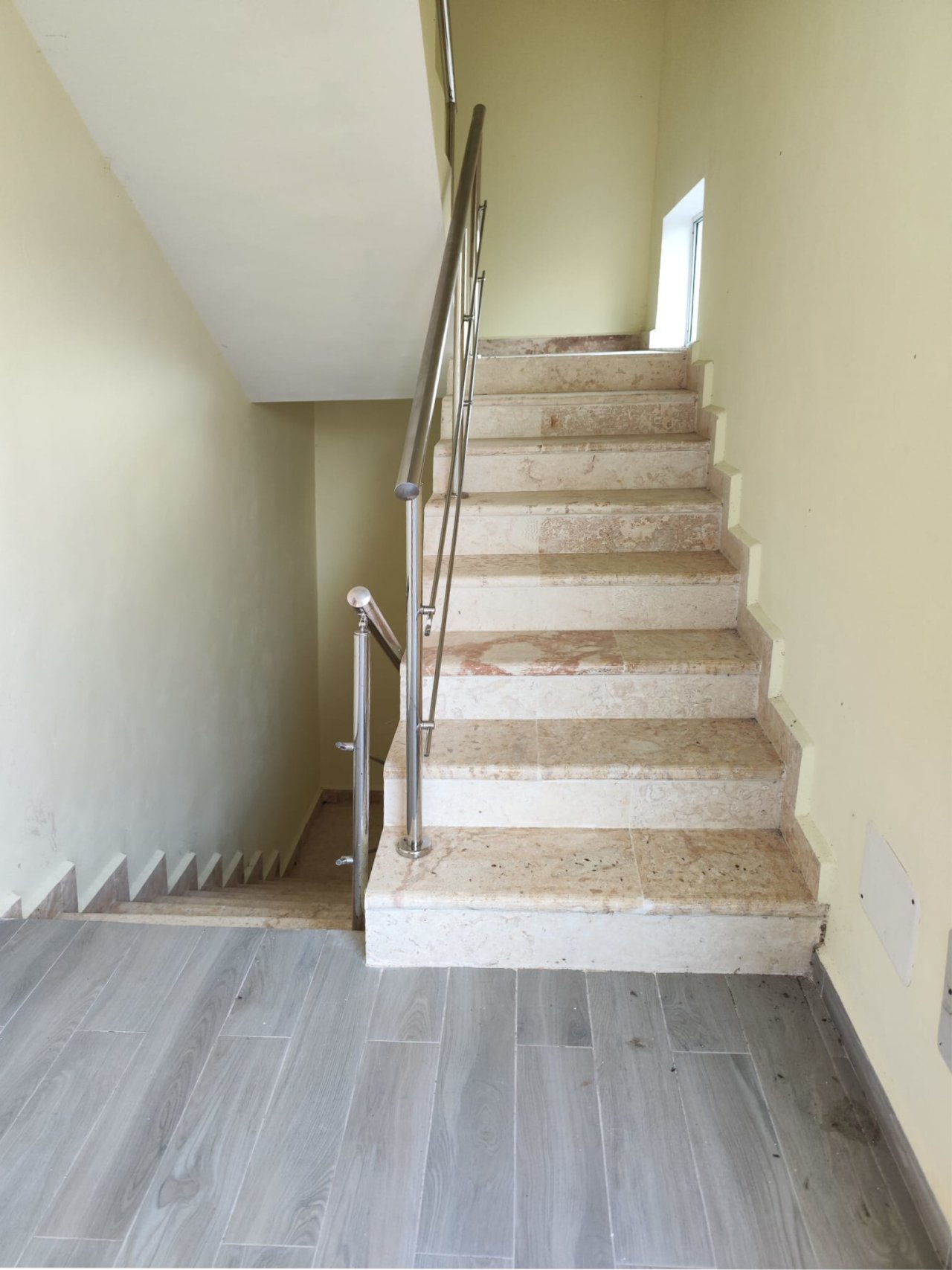 Modern staircase with steel railing and optimal lighting Modern staircase with steel railing and optimal lighting