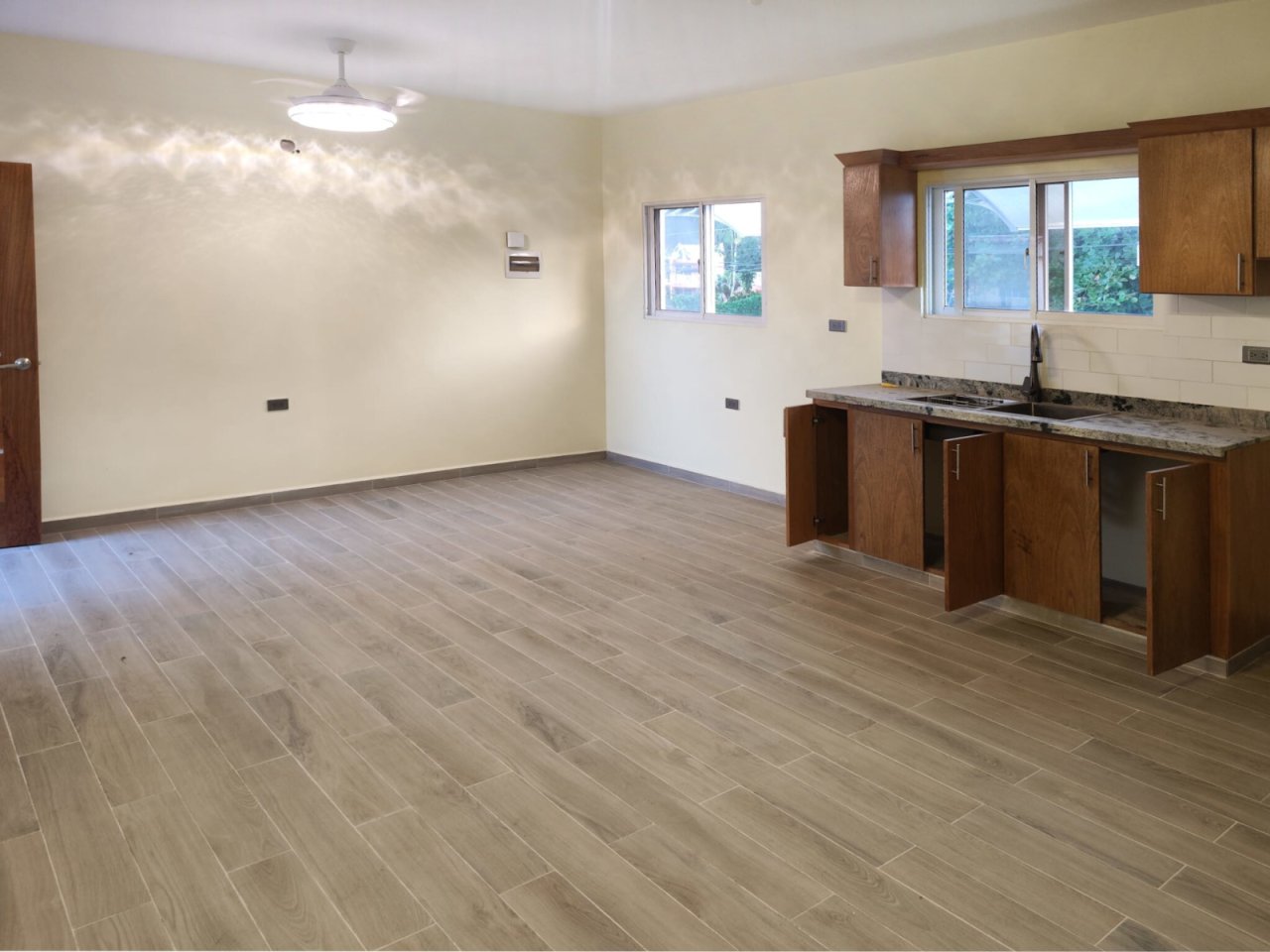Open kitchen-living area with practical layout and panoramic windows Open kitchen-living area with practical layout and panoramic windows