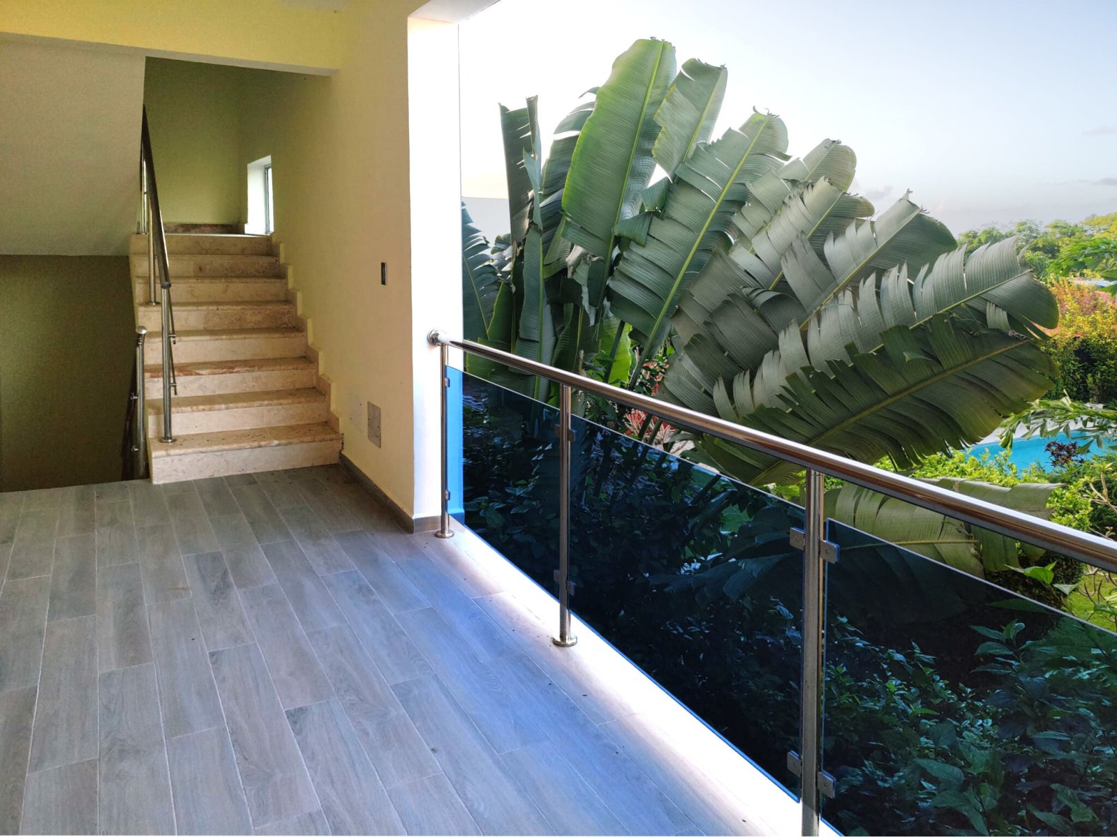 Modern staircase with floor-to-ceiling glass railings and panoramic view Modern staircase with floor-to-ceiling glass railings and panoramic view