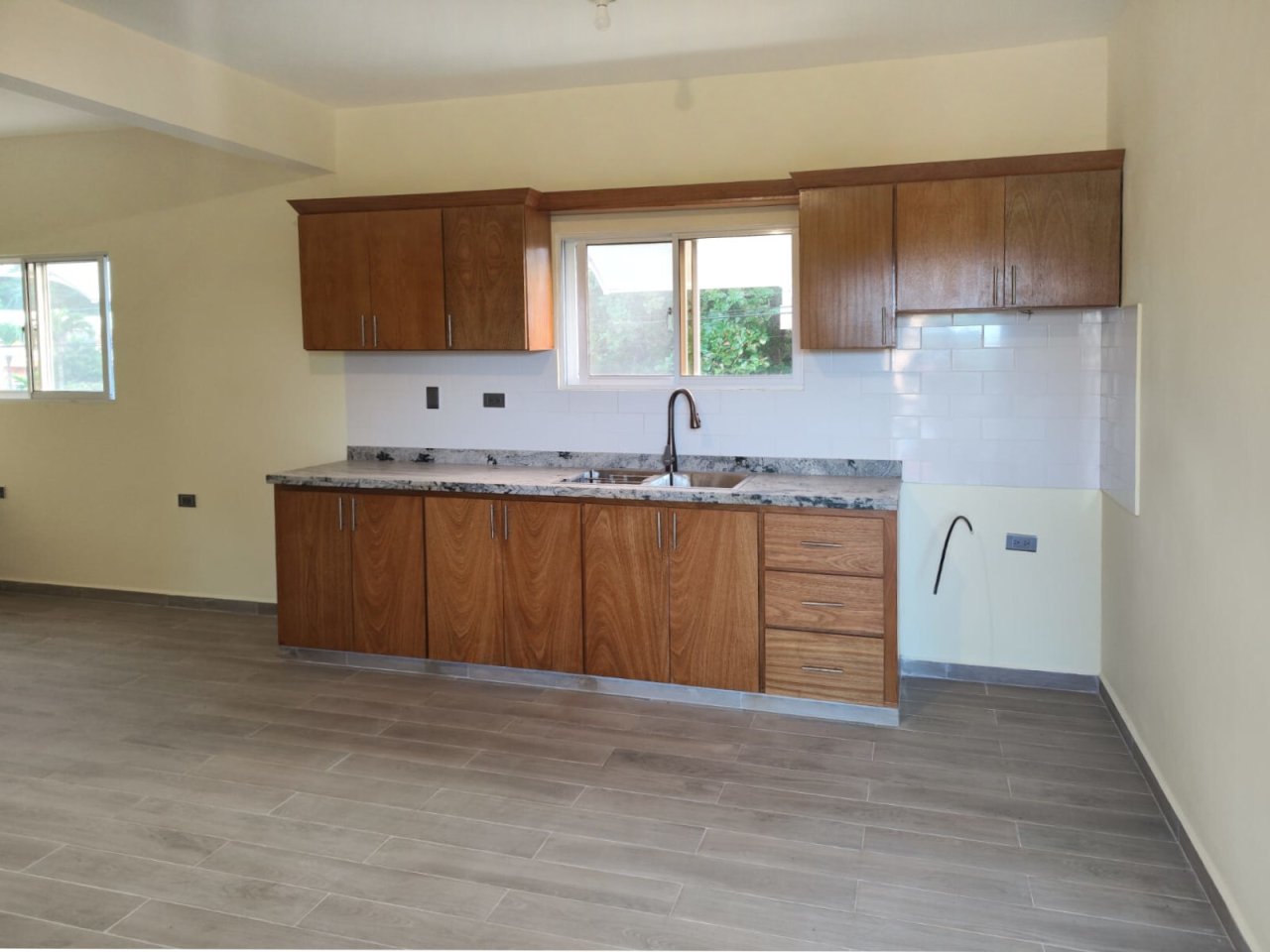 Modern kitchen with high-quality granite countertop and optimal window placement Modern kitchen with high-quality granite countertop and optimal window placement