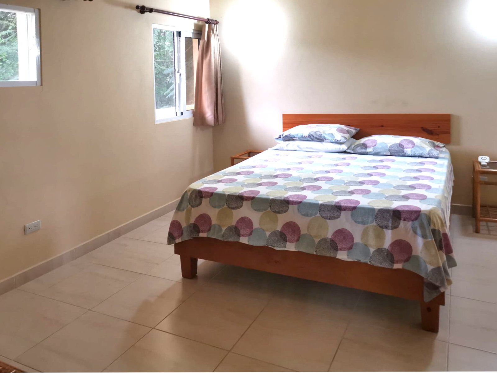 Bright bedroom with window front and practical tiled flooring
