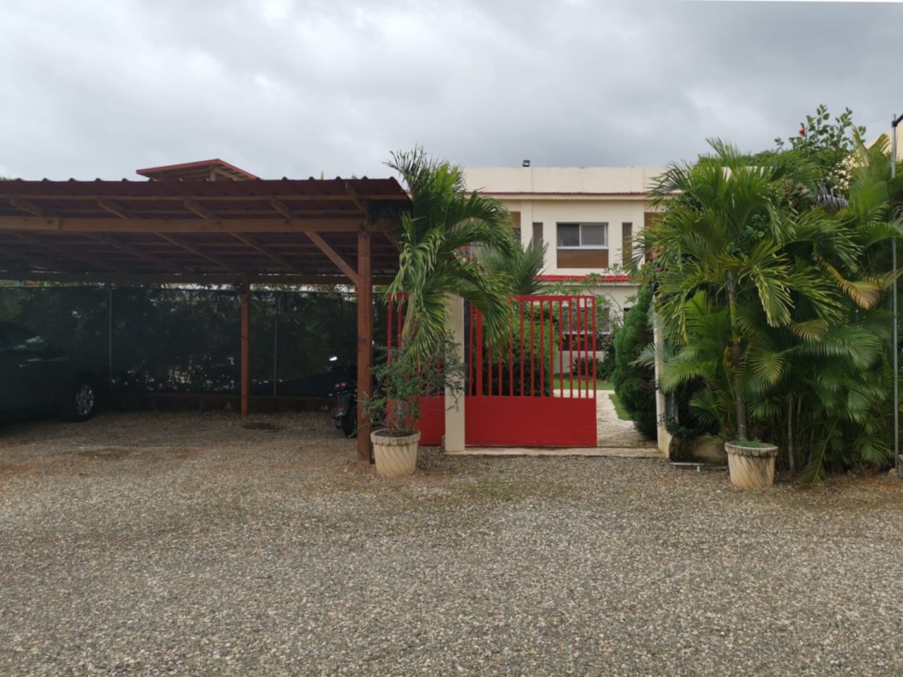 Practical outdoor area with covered parking space and secure access zone