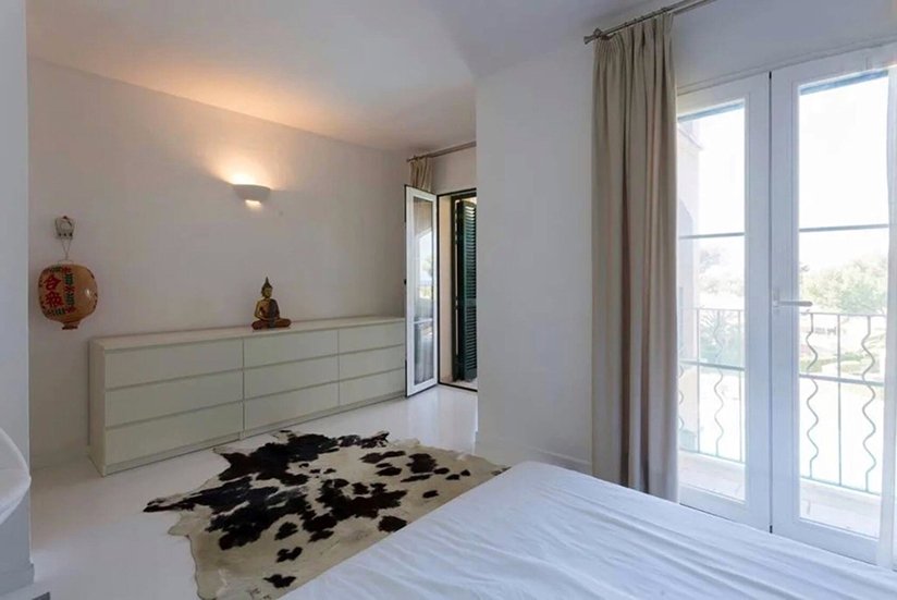 Elegant bedroom with walk-in closet and French balcony doors