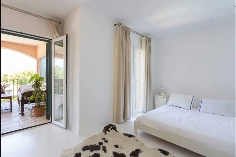 Bright bedroom with terrace access and large window design