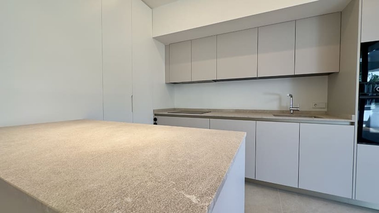 Modern kitchen with central island and extensive storage solution Modern kitchen with central island and extensive storage solution