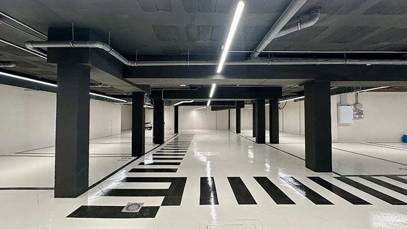 Modern underground parking area with optimal column layout and professional LED lighting Modern underground parking area with optimal column layout and professional LED lighting