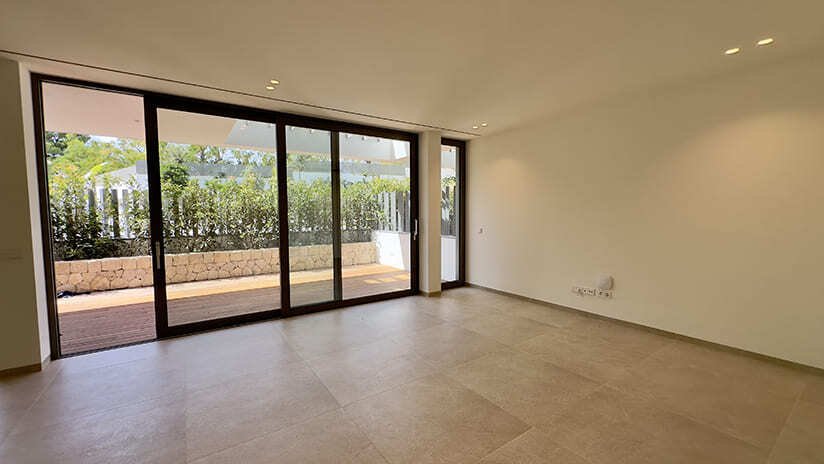 Bright living area with floor-to-ceiling sliding elements and direct terrace access Bright living area with floor-to-ceiling sliding elements and direct terrace access