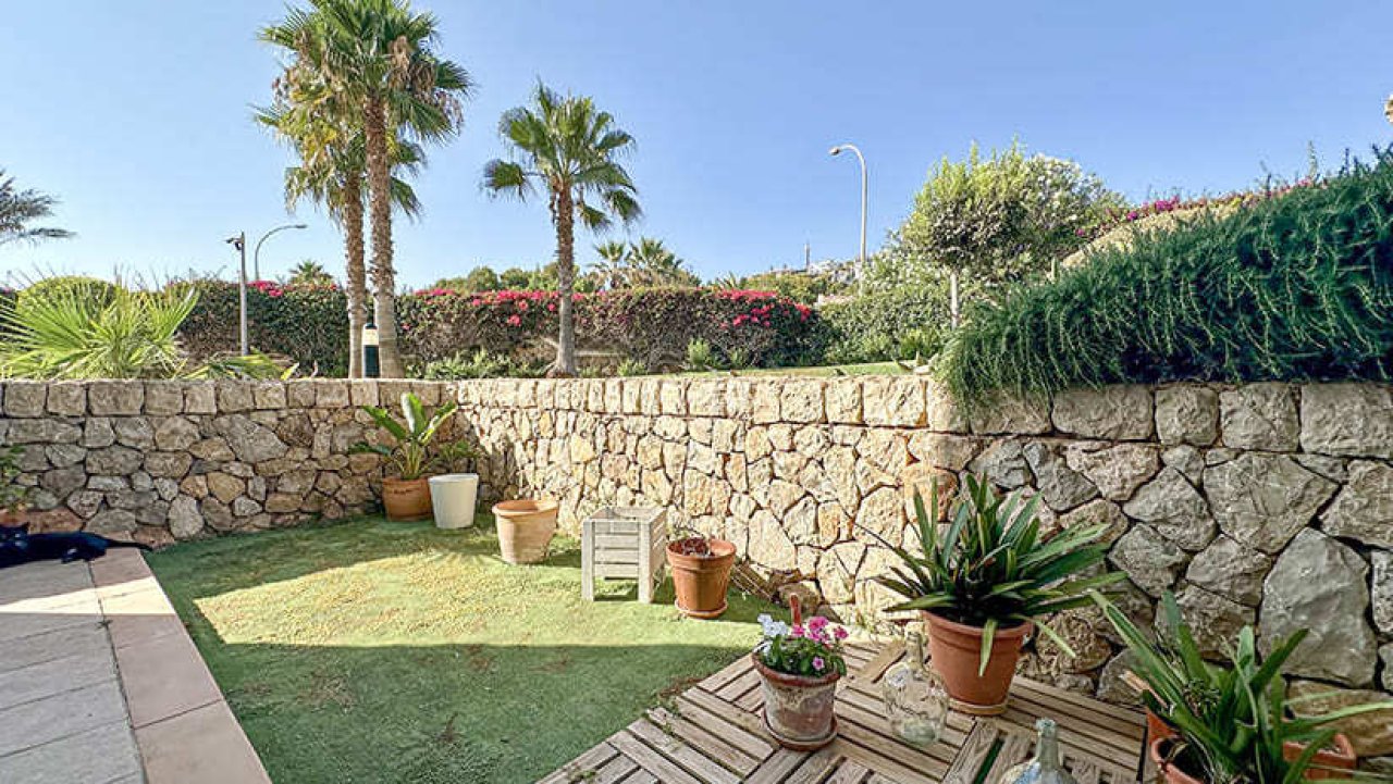 Private garden area with solid natural stone wall and extensive greenery