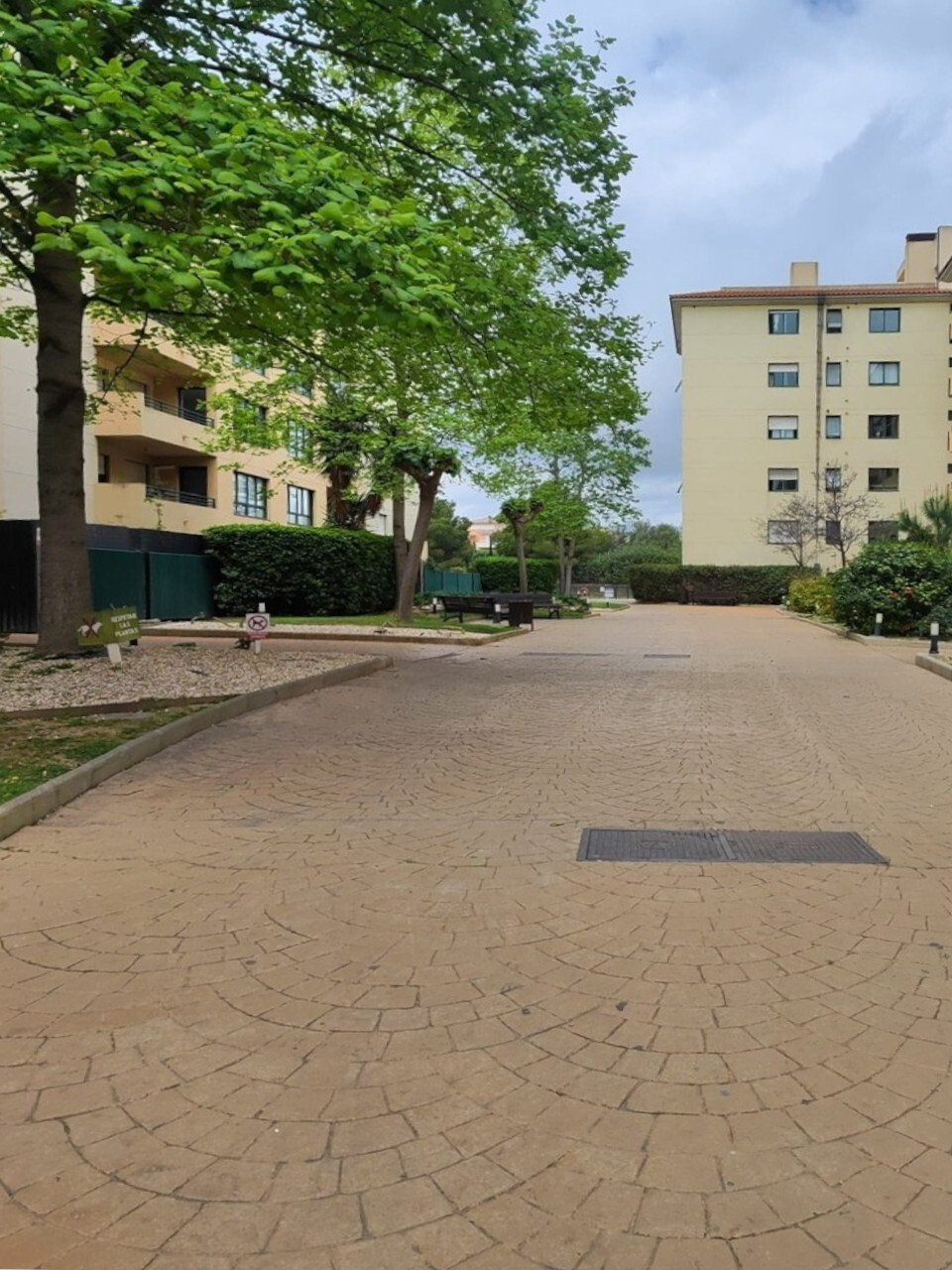 Well-maintained residential complex with harmonious architecture and a green courtyard area