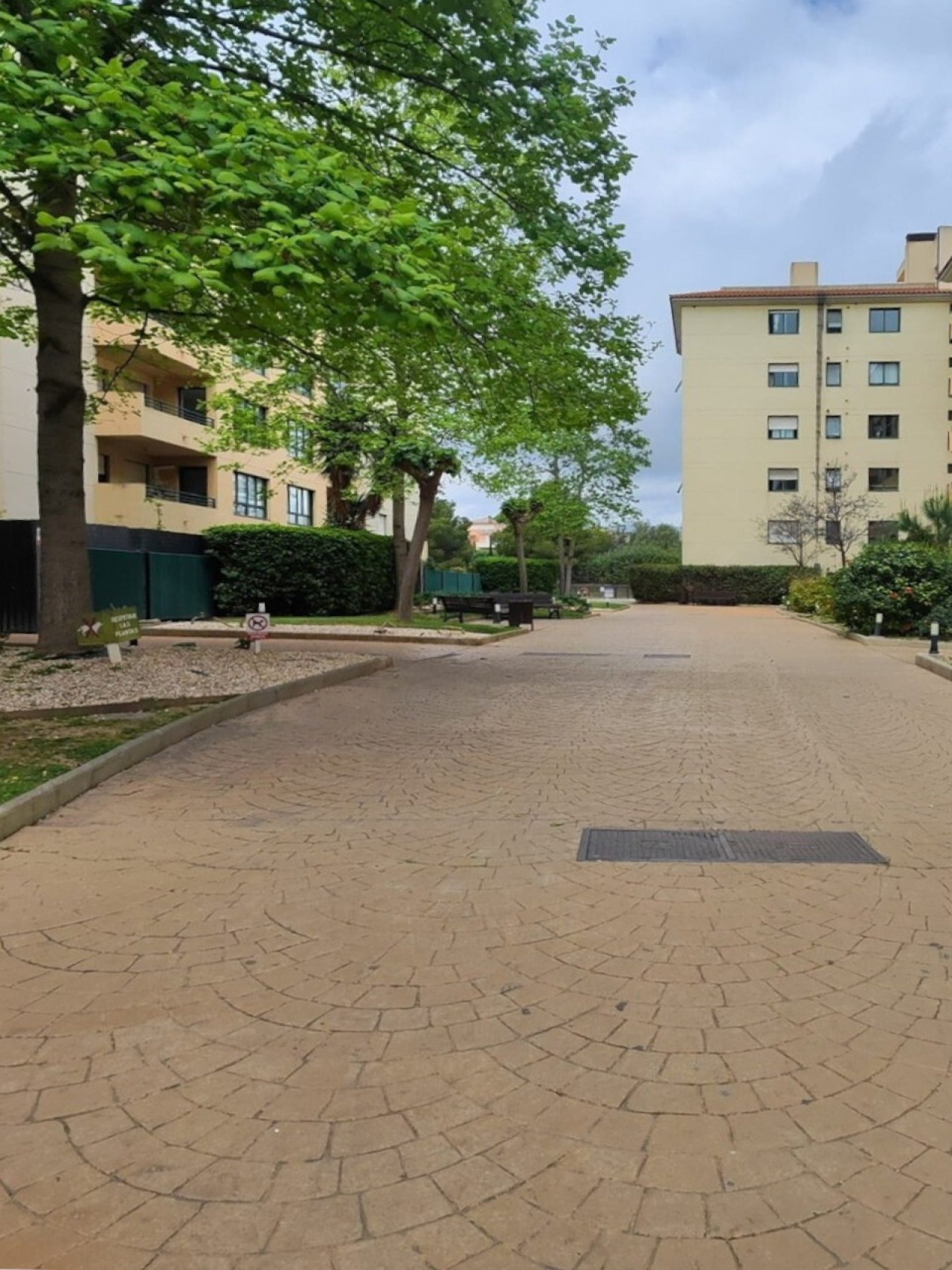 Well-maintained residential complex with harmonious architecture and a green courtyard area