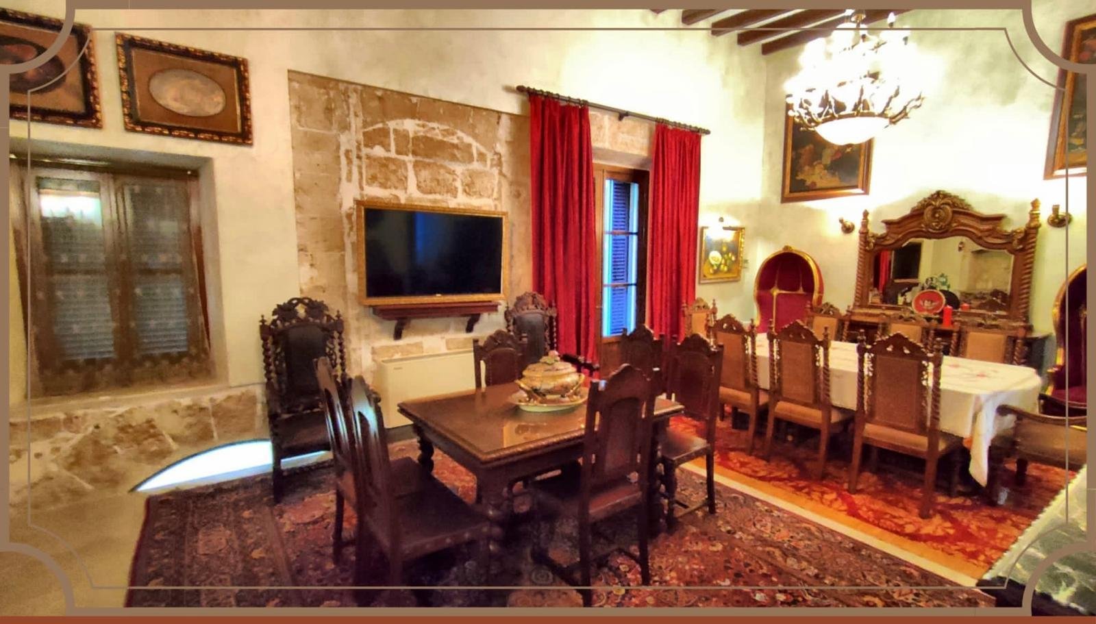 Representative living room with authentic stone wall and elegant coffered ceiling Representative living room with authentic stone wall and elegant coffered ceiling