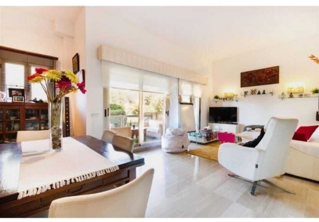 Bright living room with direct terrace access and large sliding elements Bright living room with direct terrace access and large sliding elements
