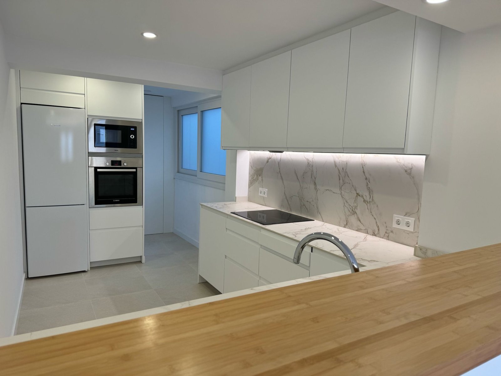 Modern kitchen with high-quality built-in appliances and intelligent workspace layout