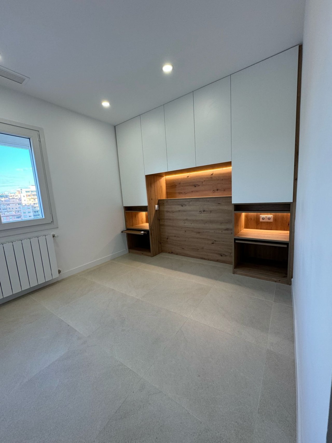 Bedroom with custom-built wardrobes and integrated lighting