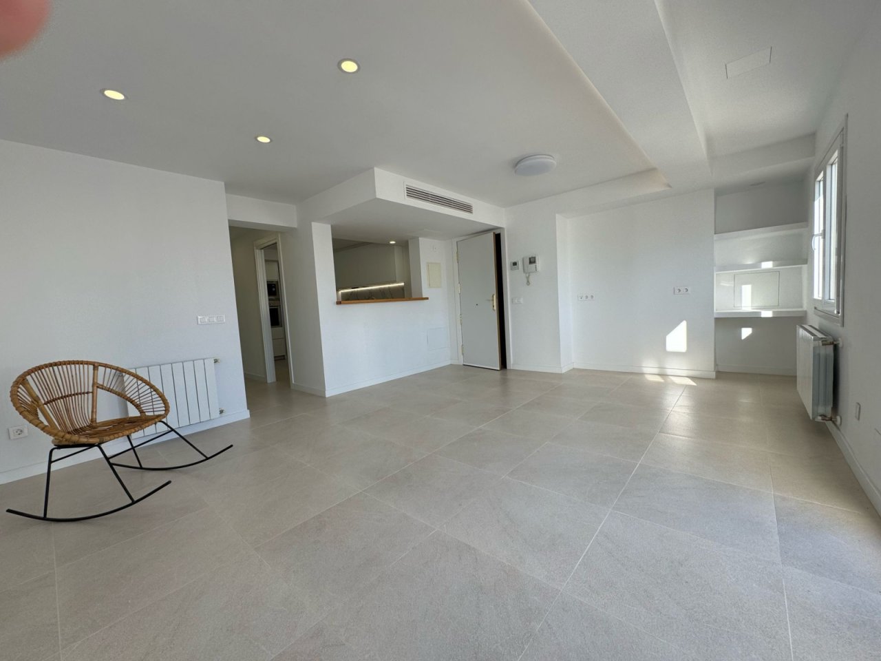 Open living and kitchen concept with high-quality furnishings and air conditioning.
