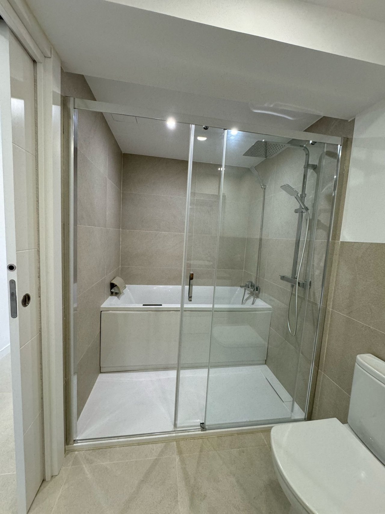 Luxurious bathroom with walk-in shower and integrated bathtub