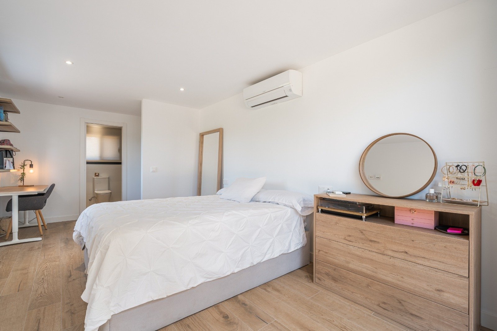 Comfortable bedroom with integrated workspace and modern air conditioning