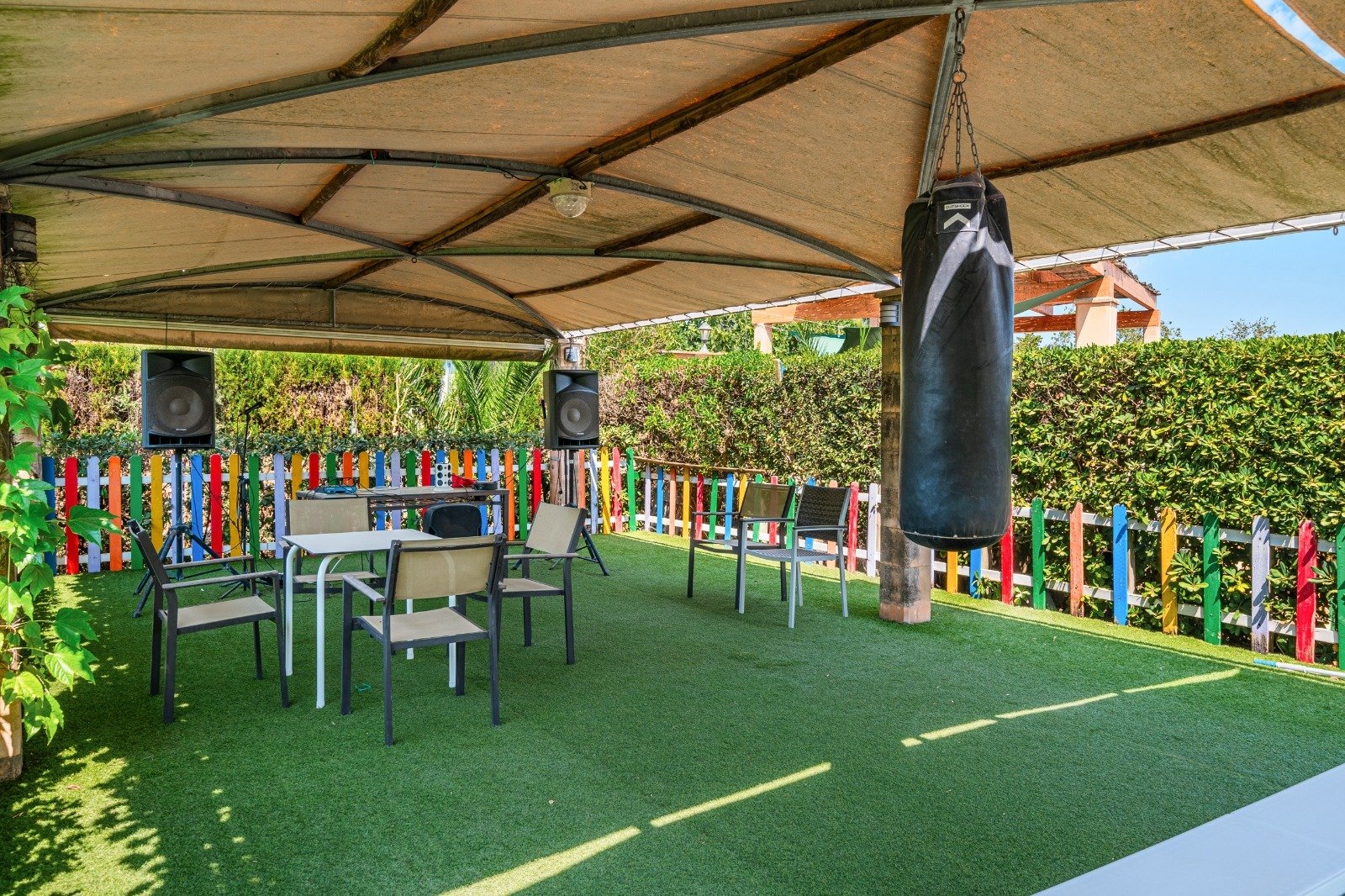 Covered outdoor area with a sturdy steel structure and versatile usage options
