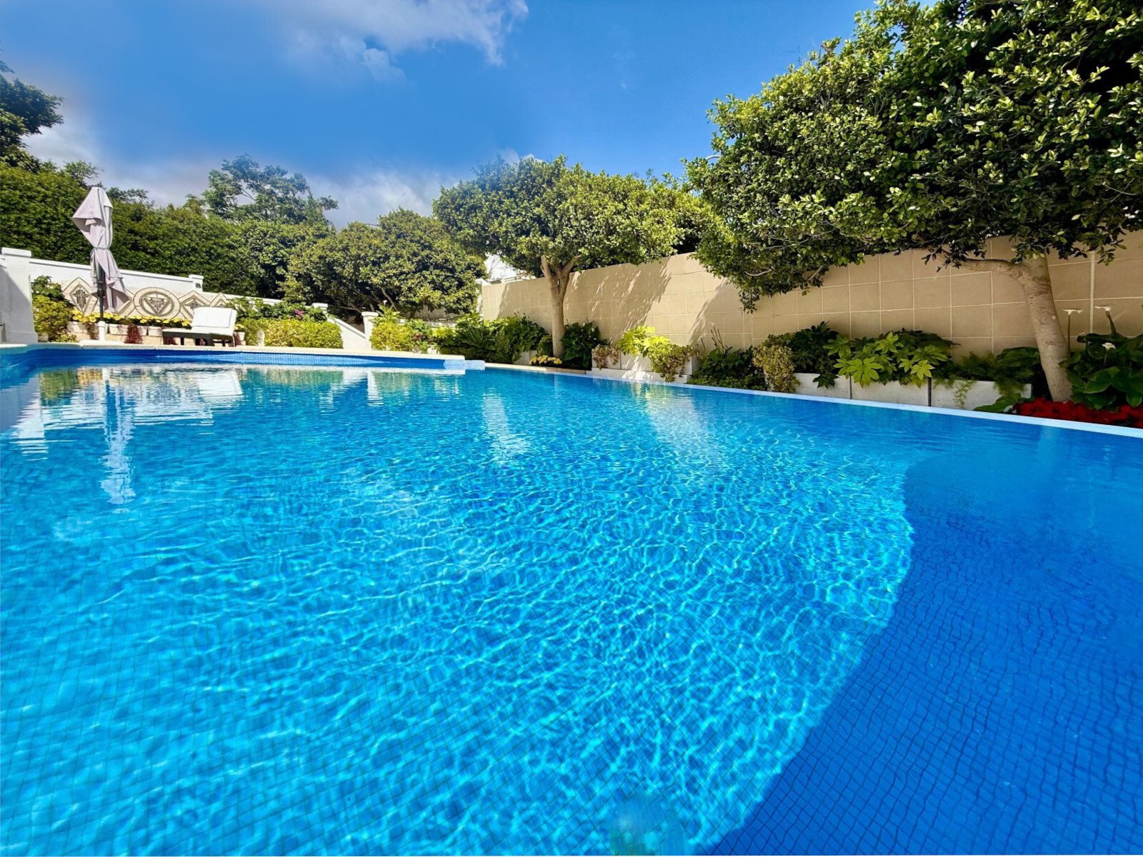 Refreshing oasis with a large swimming pool and surrounding terrace area Refreshing oasis with a large swimming pool and surrounding terrace area