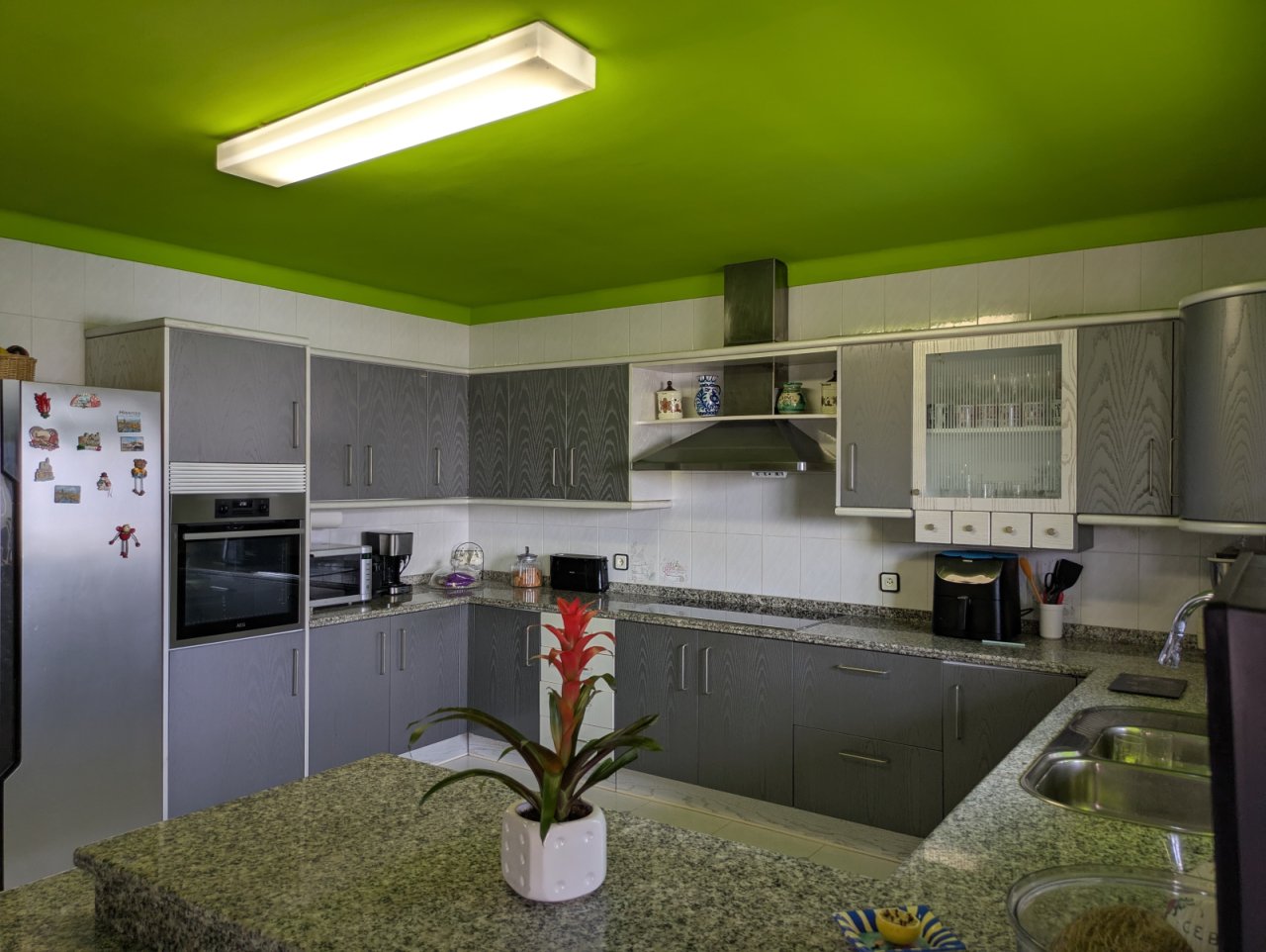 Modern kitchen with island, granite countertop, and high-quality built-in appliances