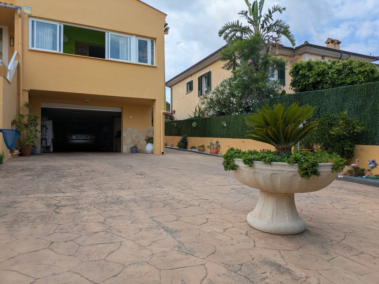 Paved courtyard area with integrated garage and enclosed outdoor space