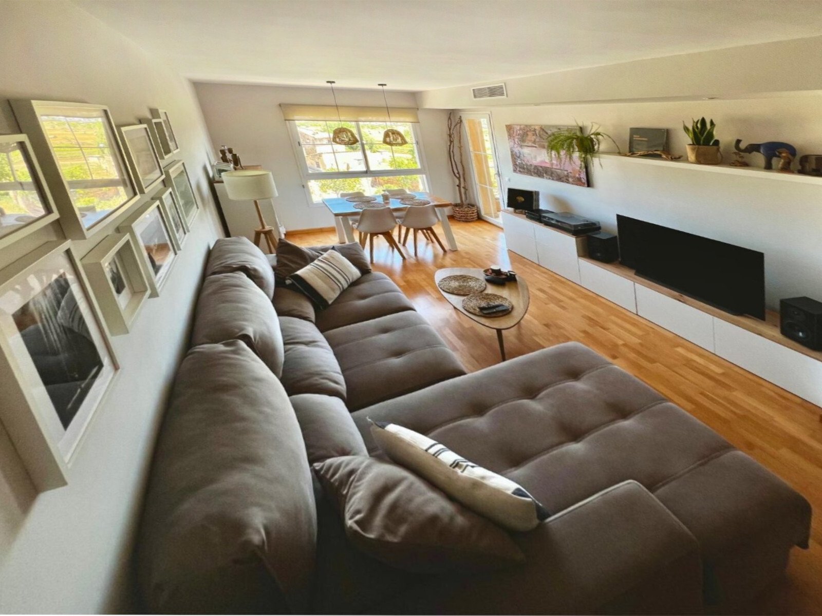 Bright living room with flowing room connections and extensive window frontage