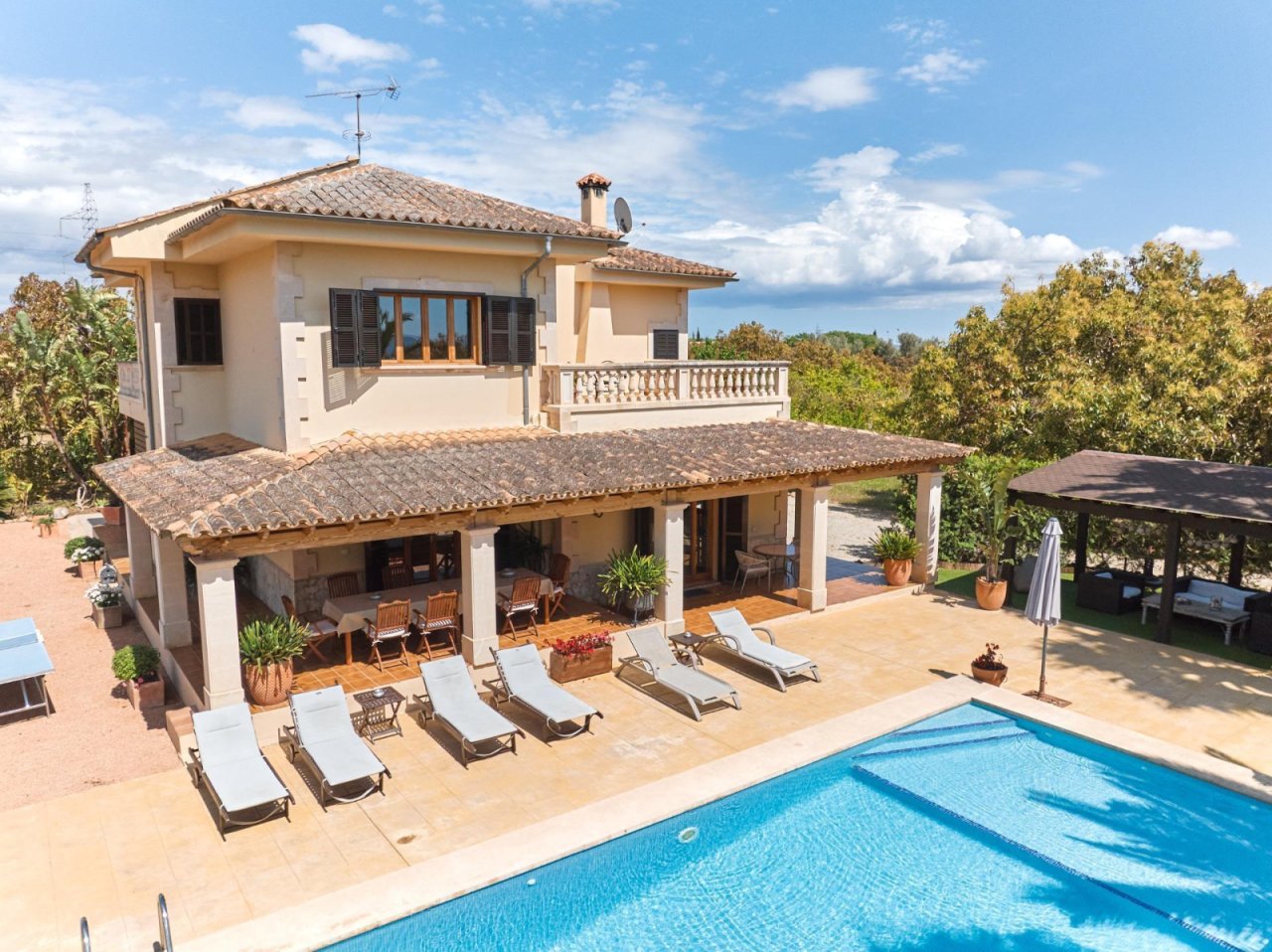 Elegant pool area with a covered lounge and thoughtful outdoor design Elegant pool area with a covered lounge and thoughtful outdoor design