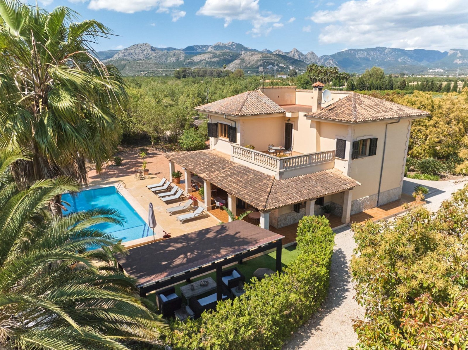 Aerial view: Mediterranean villa with impressive pool area and mountain panorama Aerial view: Mediterranean villa with impressive pool area and mountain panorama