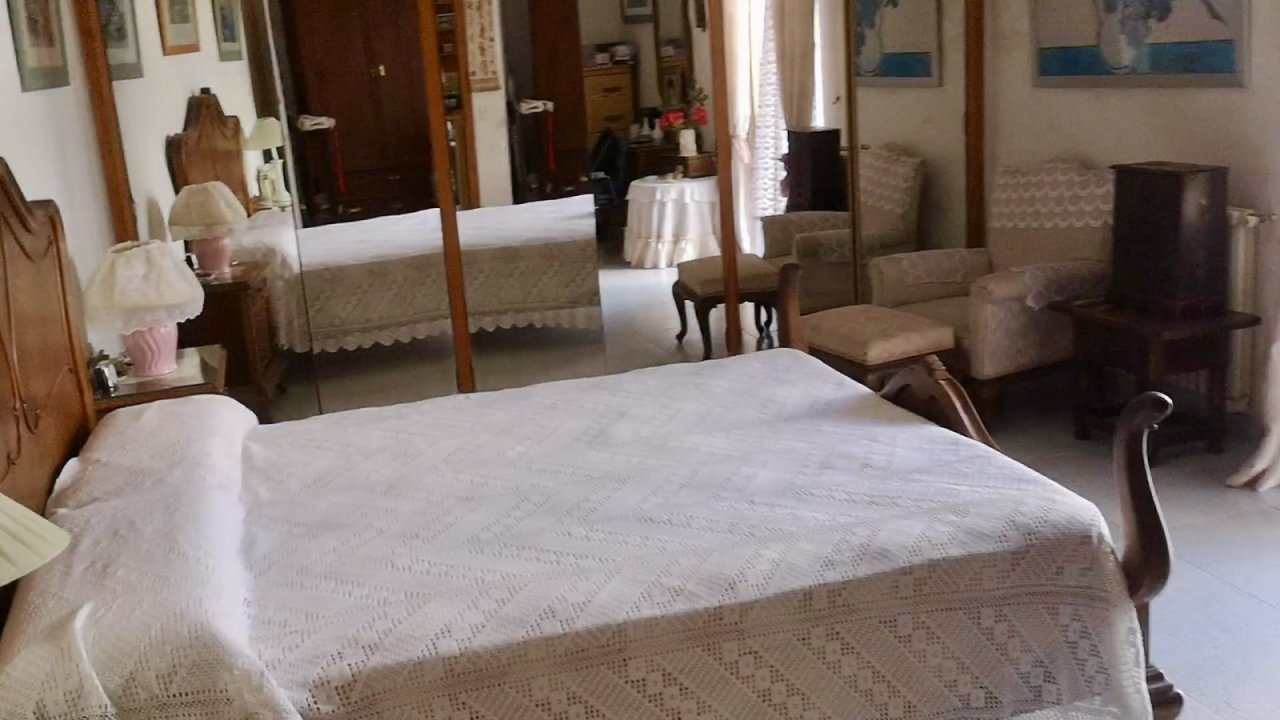 Spacious master bedroom with large mirror system and versatile storage solutions