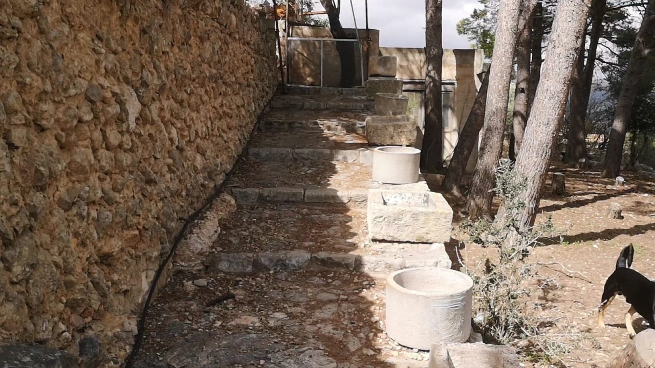 Rustic side path with authentic natural stone walls and direct access to the pool area