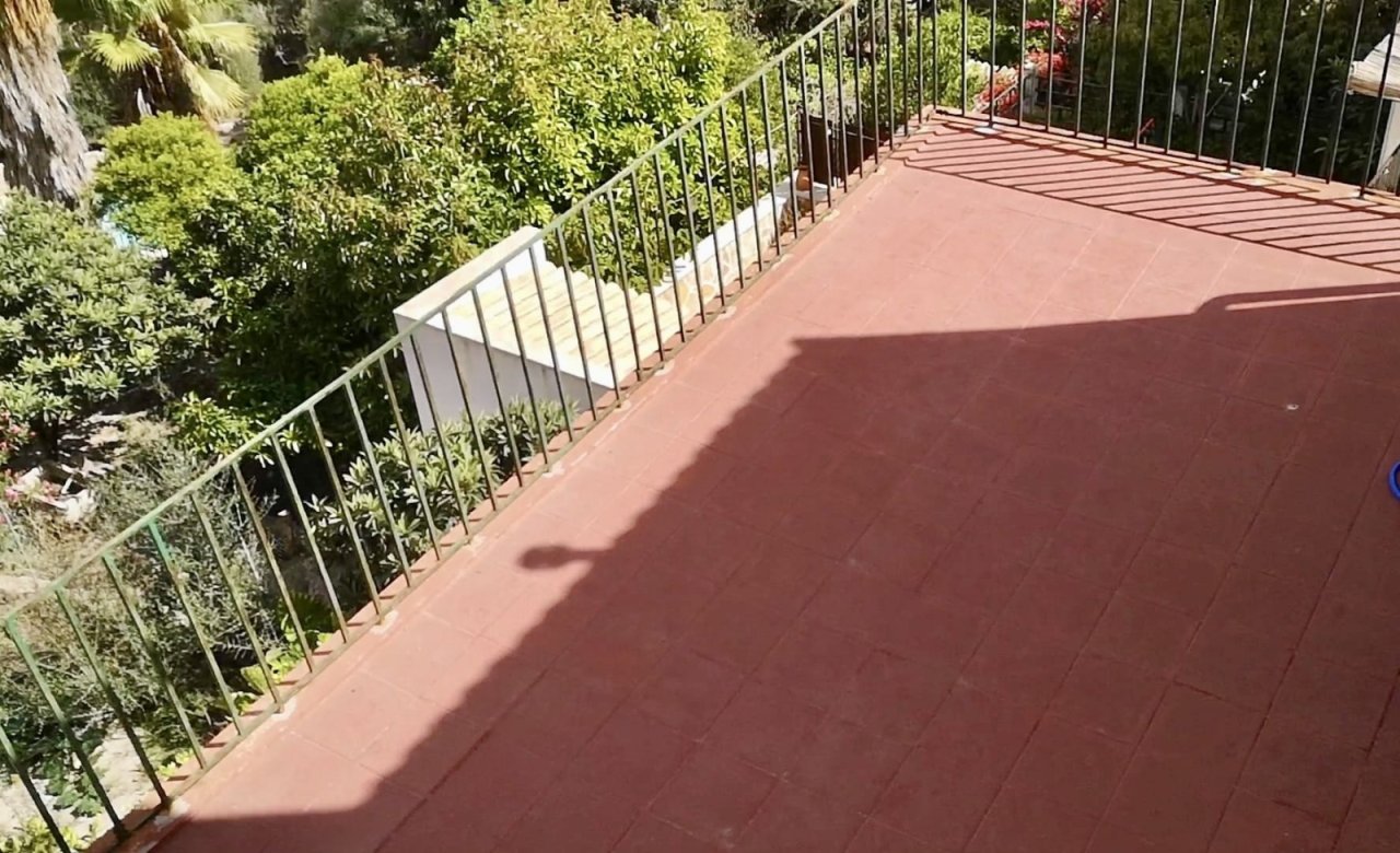 Sunlit terrace with a secure metal railing and high-quality surface finish