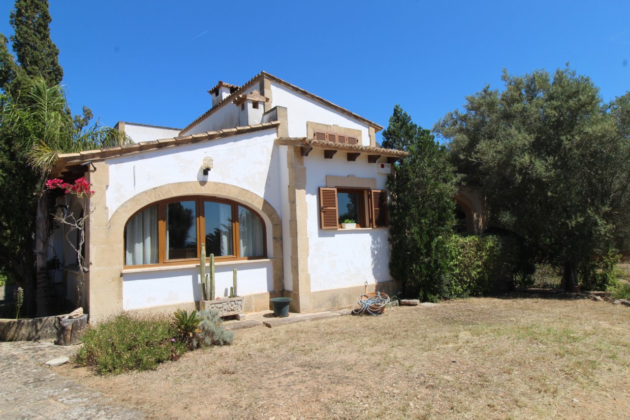 Charming south facade with distinctive arched windows and direct access to the outdoor area