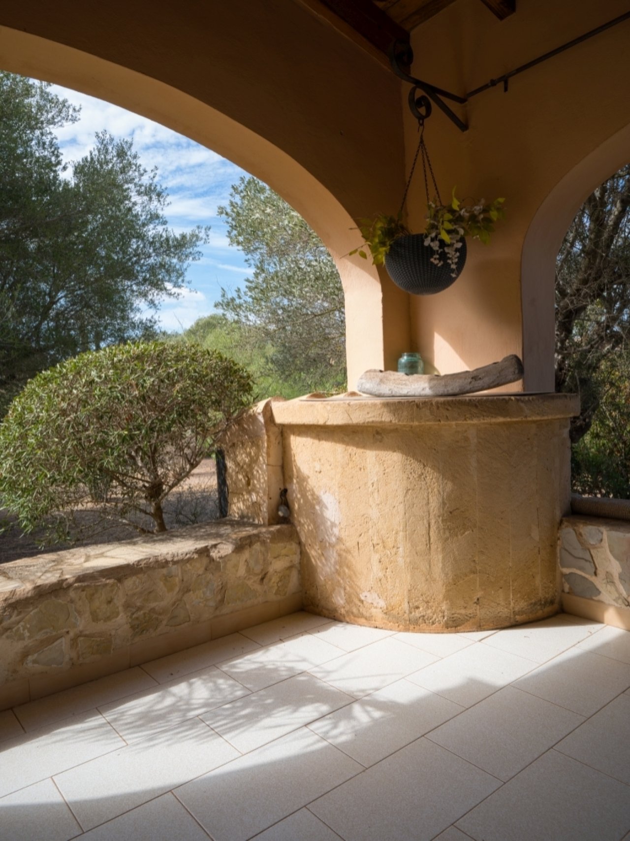 Covered loggias with natural stone walls and an unobstructed view of the greenery